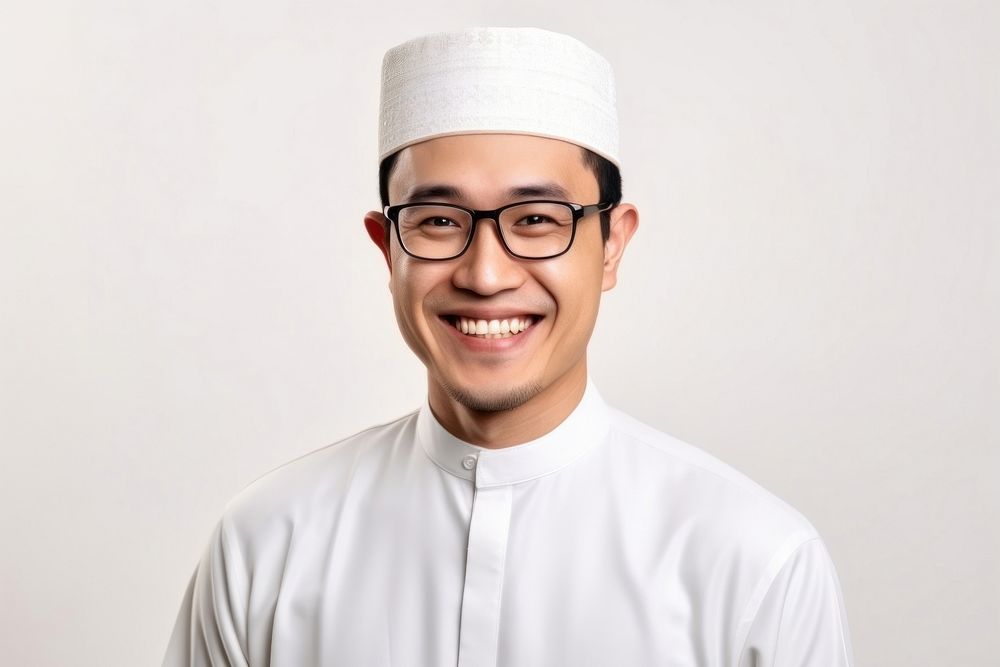 Muslim man glasses portrait smiling.