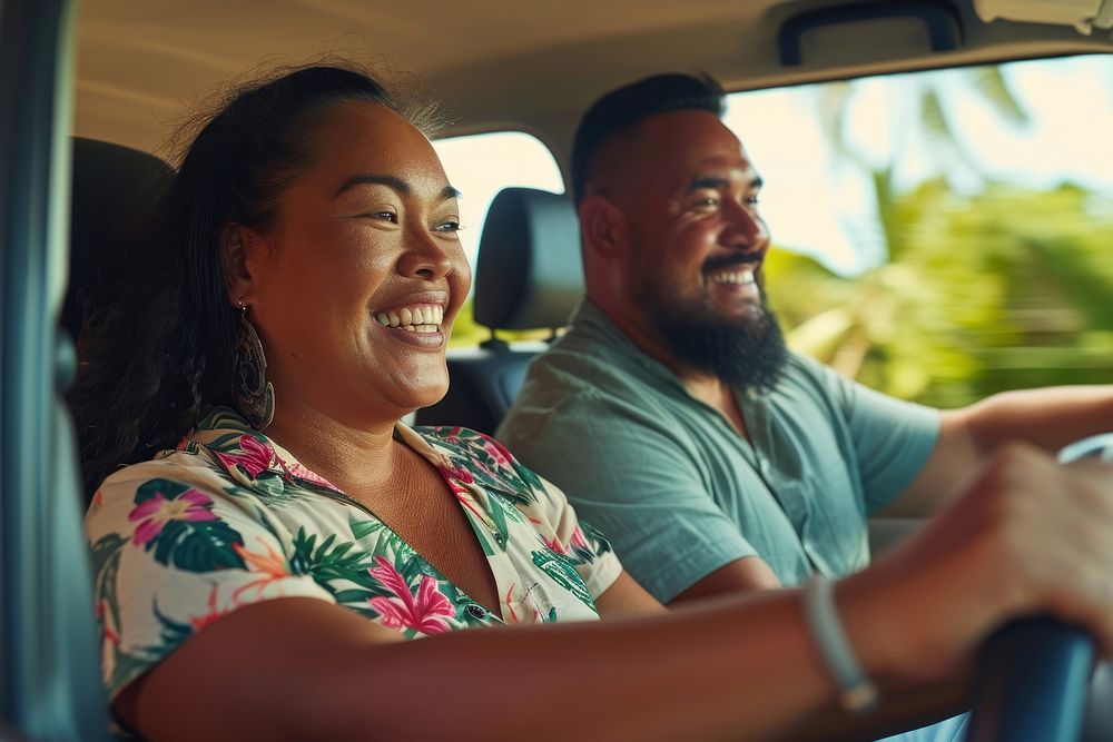 Samoan couple driving laughing vehicle.
