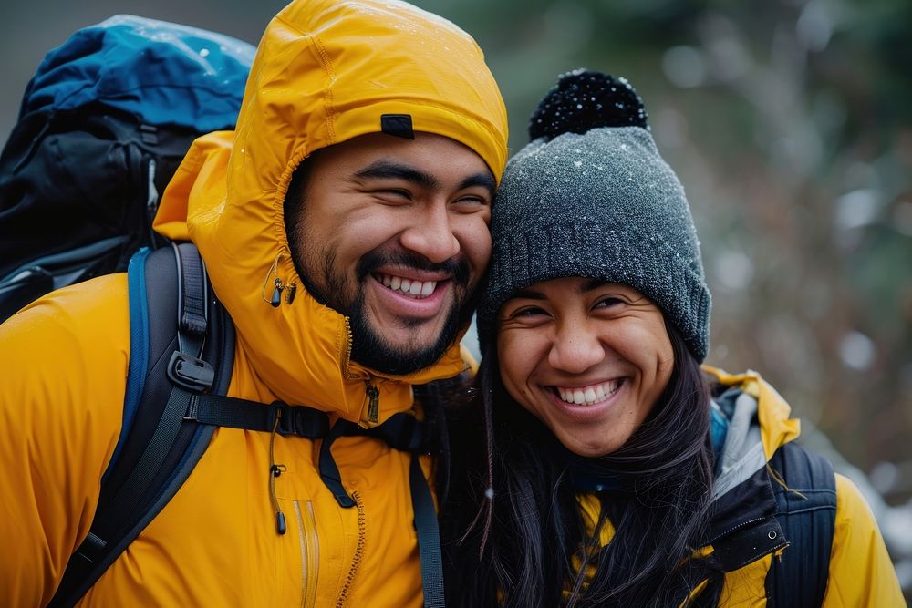 Samoan couple jacket backpack laughing.