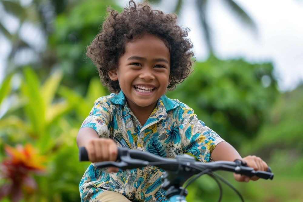 Samoan kid outdoors bicycle vehicle.