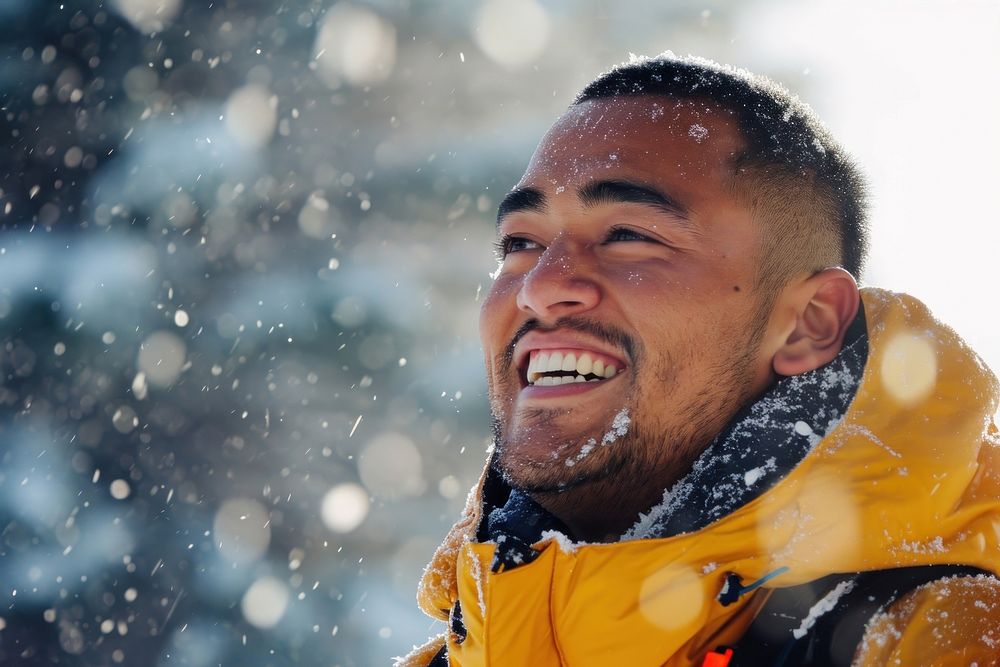 Samoan man outdoors snow laughing.