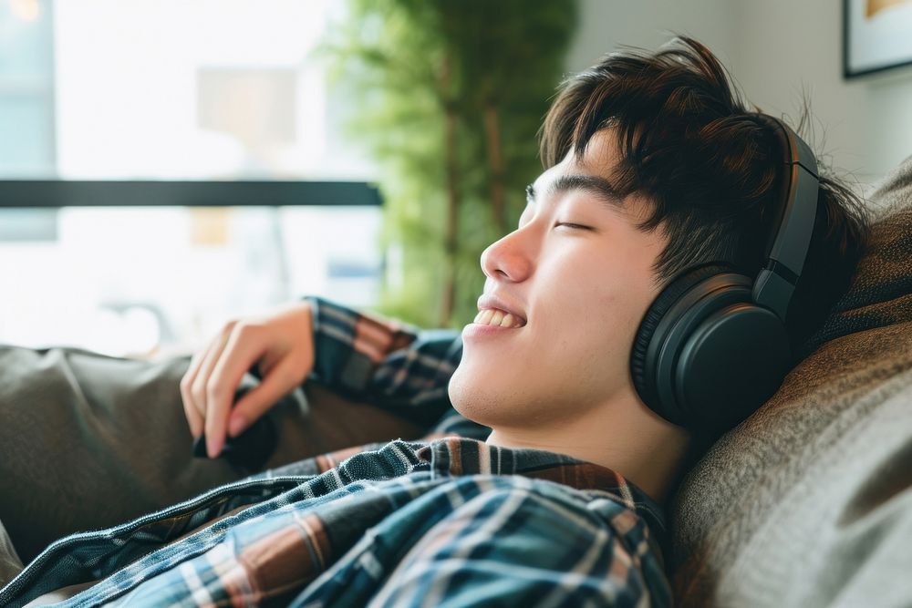 Asian man headphones headset comfortable.