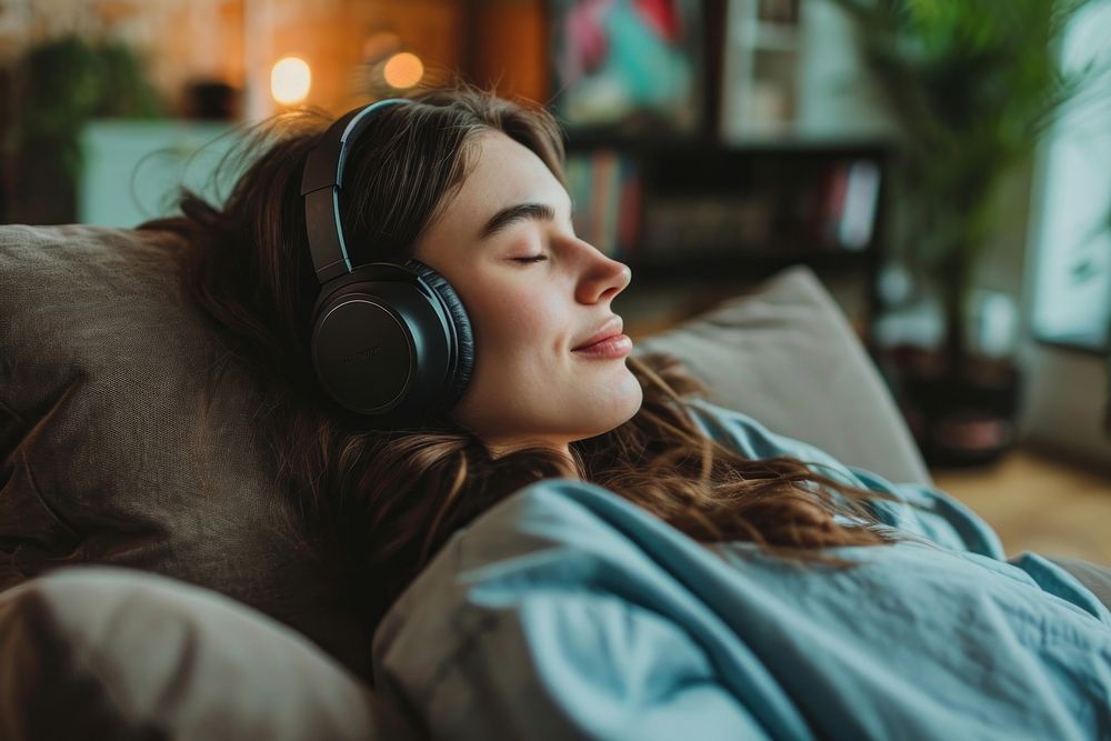 British girl headphones comfortable living room.