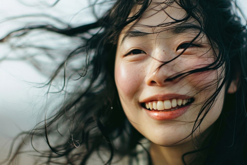 Happy woman smiling face with blowing wind on her hair laughing smile happiness. AI generated Image by rawpixel.