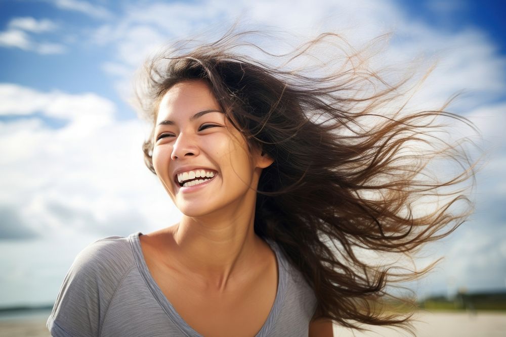 Happy woman smiling face with blowing wind on her hair laughing smile adult. AI generated Image by rawpixel.