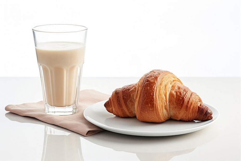 Iced coffee and croissant on plate breakfast bread drink.