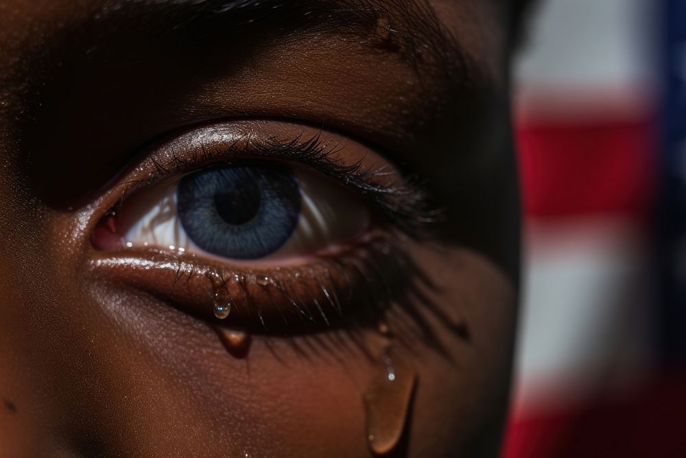 Sad African - American kid tears drop adult skin eye.