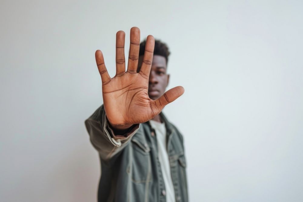 African American showing stop gesture hand finger adult.