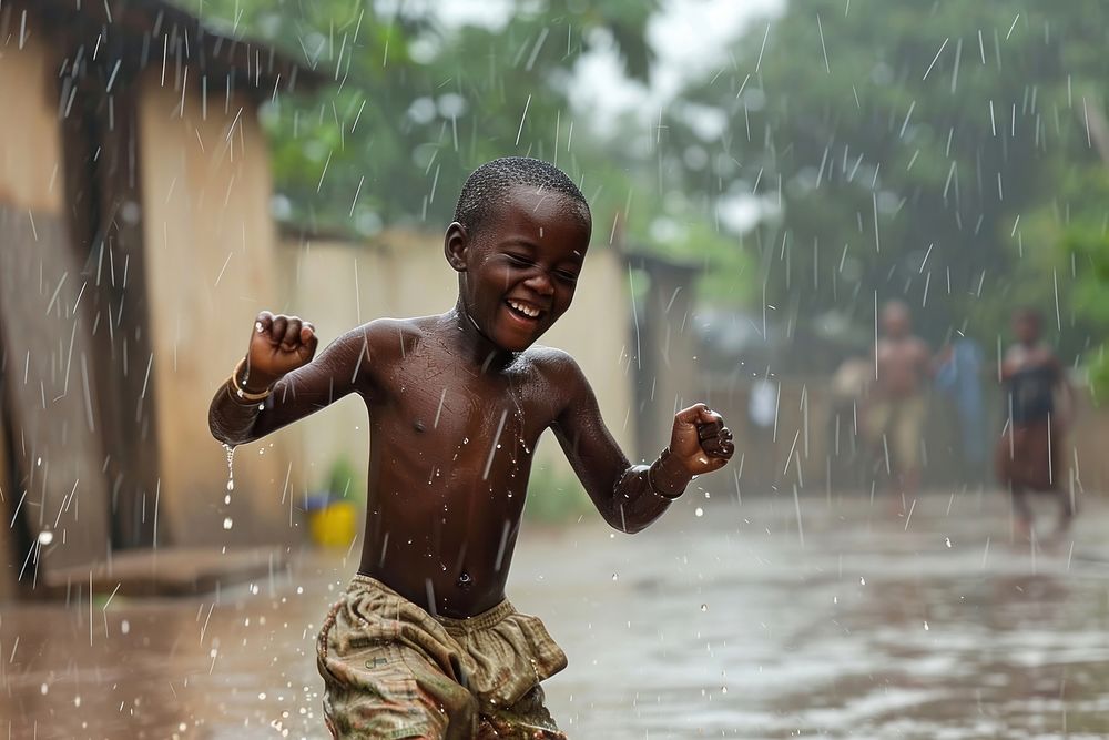 African boy dancing on the rain outdoors child architecture.