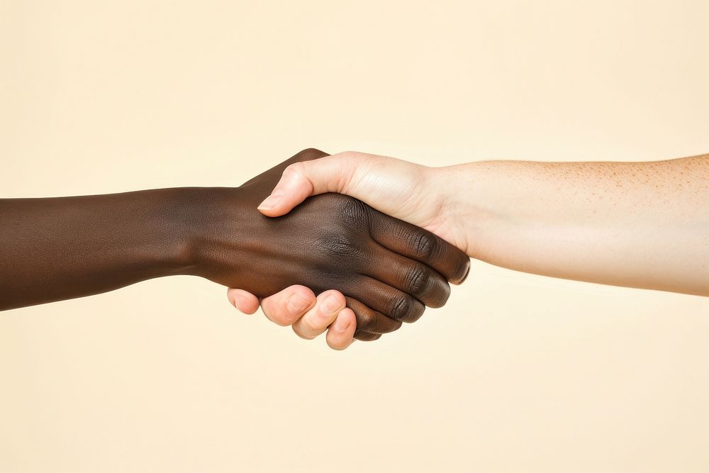 African hand and caucasian hand handshake agreement finger.