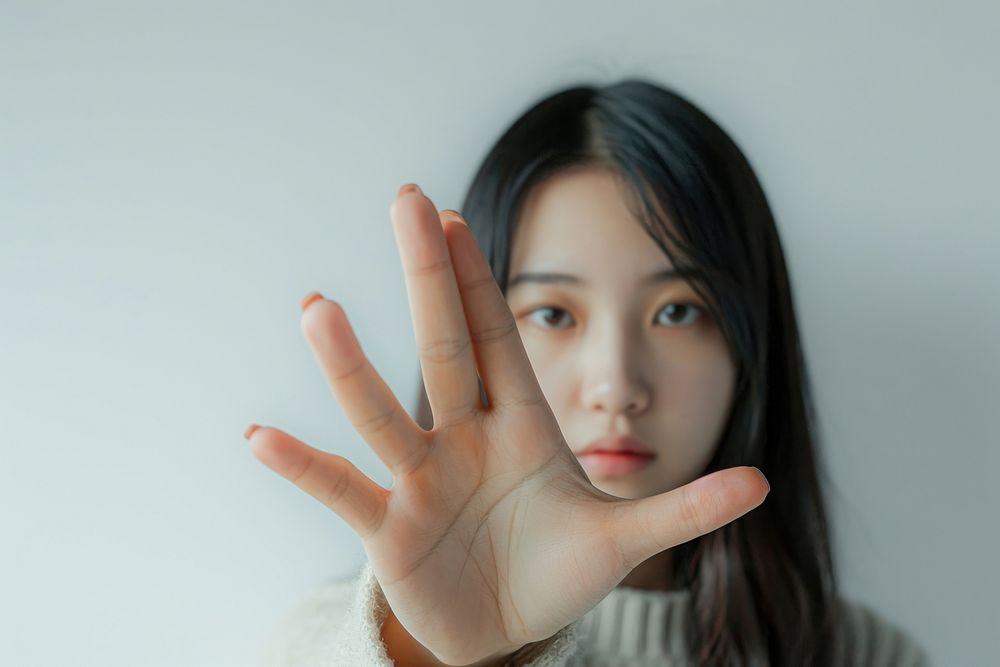 Asian Woman showing stop gesture hand skin portrait.