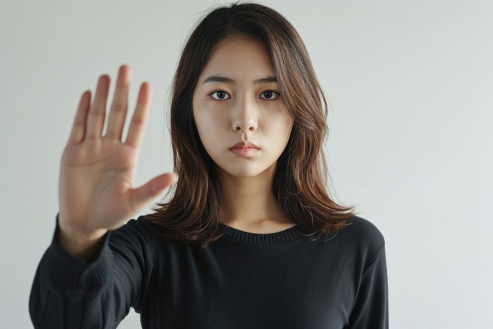 Asian Woman showing stop gesture portrait adult photo.