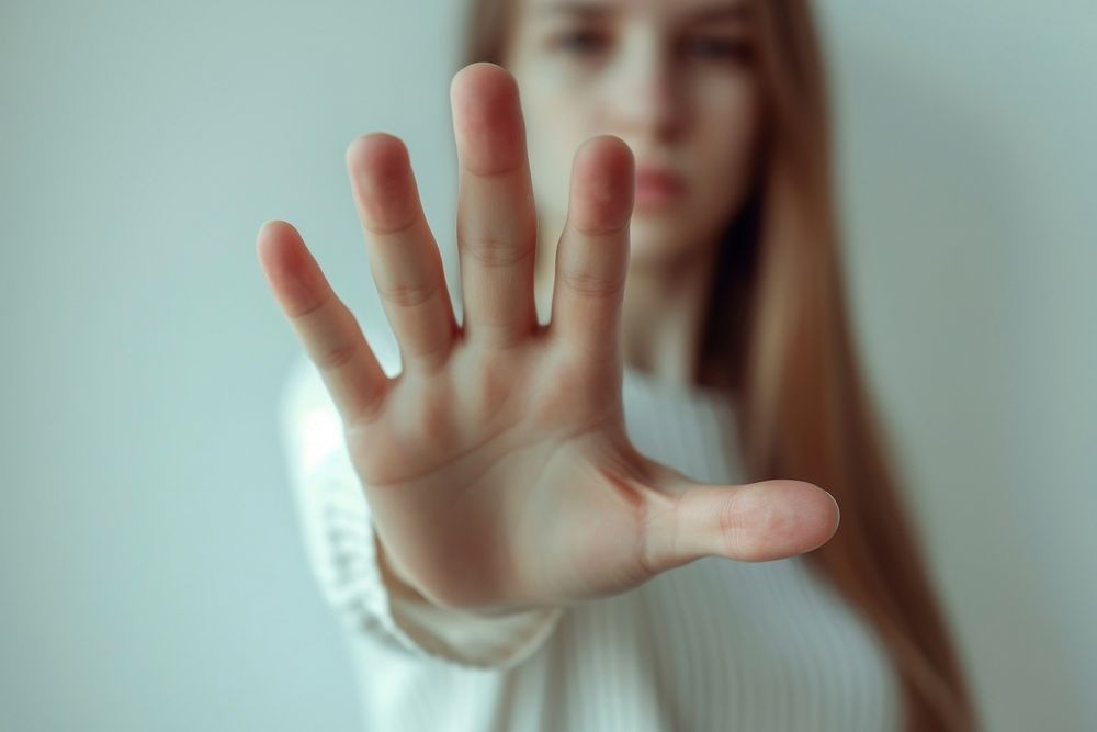 Woman showing stop gesture hand finger skin.