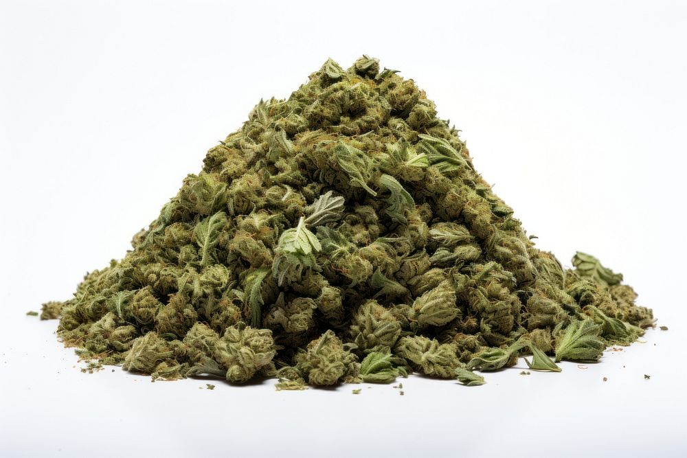 A pile of crushed cannabis plant herbs white background.
