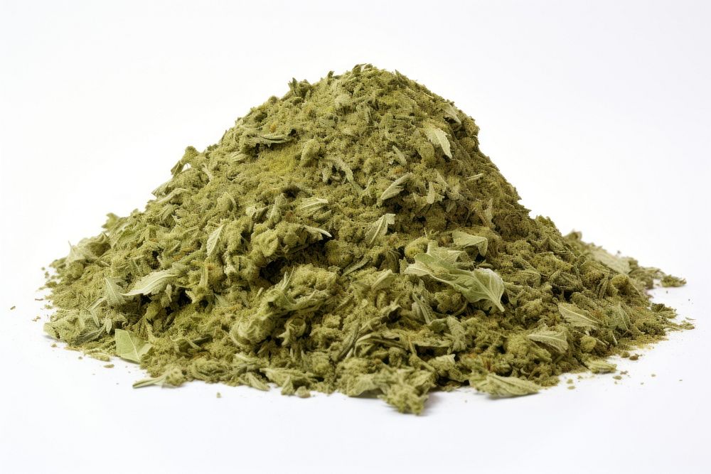 A pile of crushed cannabis plant herbs white background.