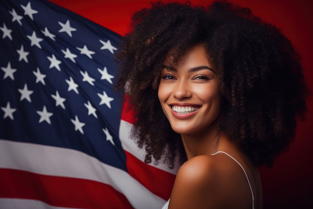 Afro American beautiful young woman holding national American flag portrait adult smile.