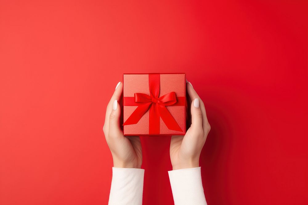 Woman hands holding a luxury gift box paper bow red. AI generated Image by rawpixel.