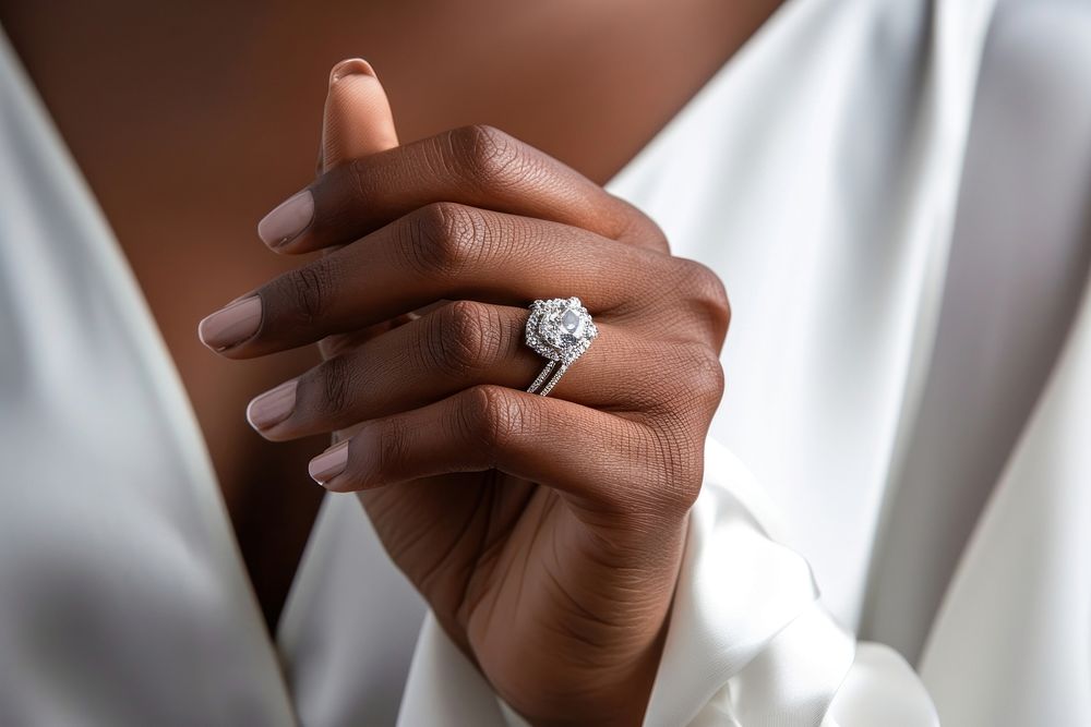 Diamond jewelry in white outfit model African American lady hand finger silver ring. AI generated Image by rawpixel.