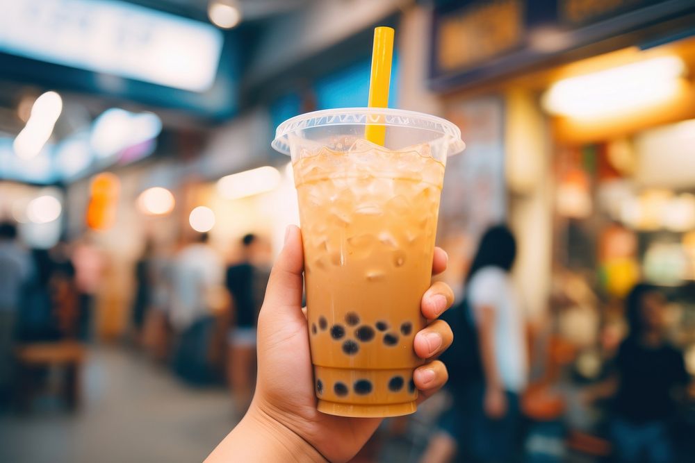 Hand holding a bubble tea drink adult refreshment. AI generated Image by rawpixel.