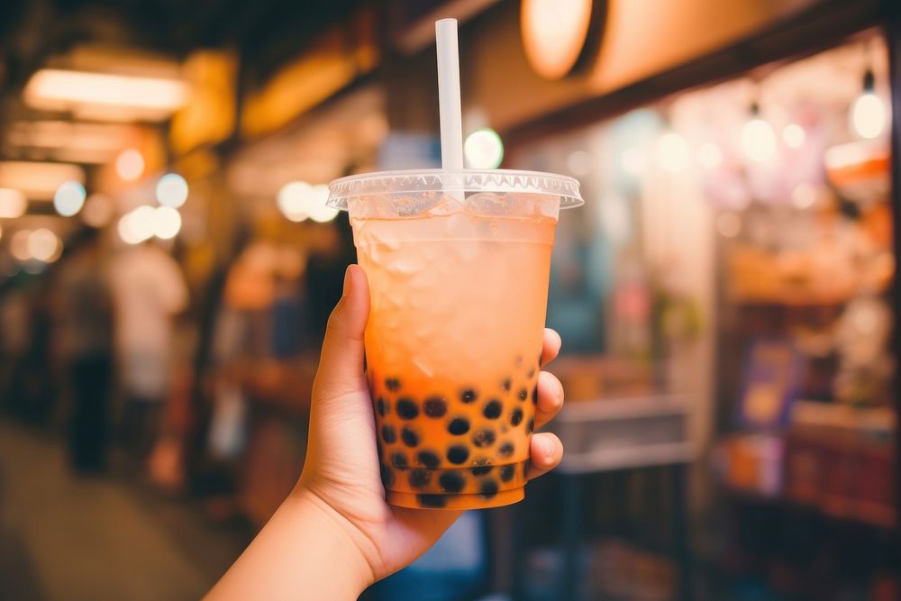 Hand holding a bubble tea drink refreshment disposable. AI generated Image by rawpixel.