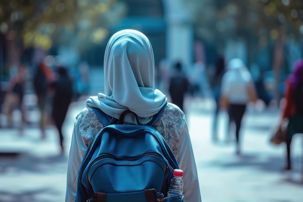 Muslim girl walking in the college adult architecture backpacking. 