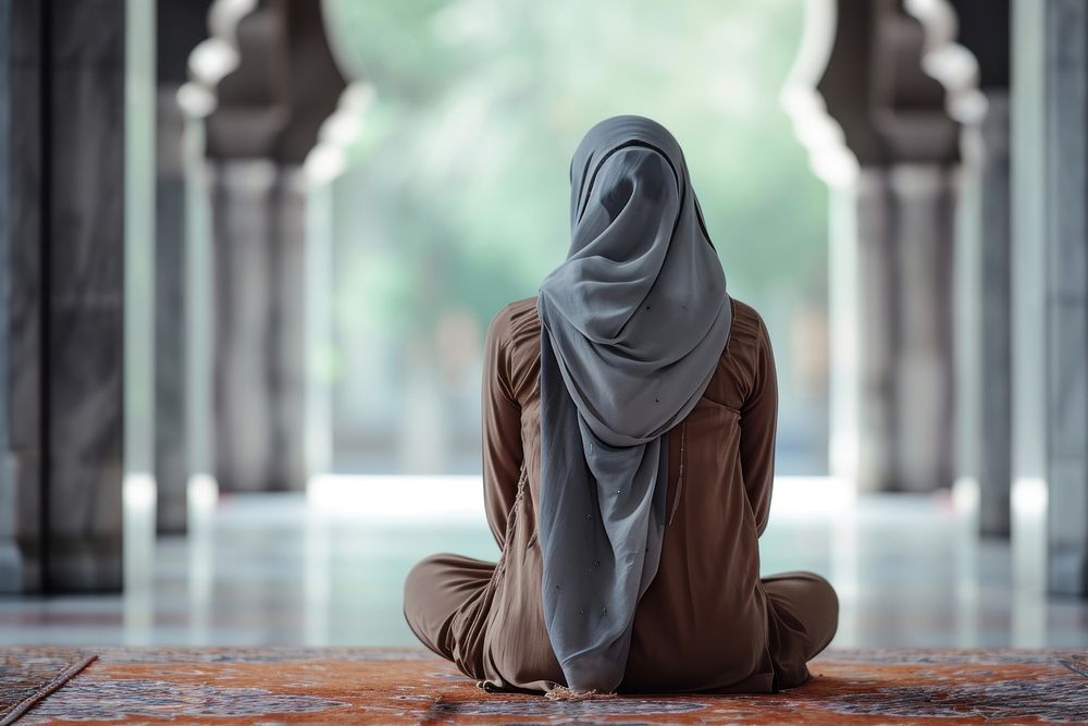 Muslim woman sitting and praying in Mosque adult contemplation spirituality. AI generated Image by rawpixel.