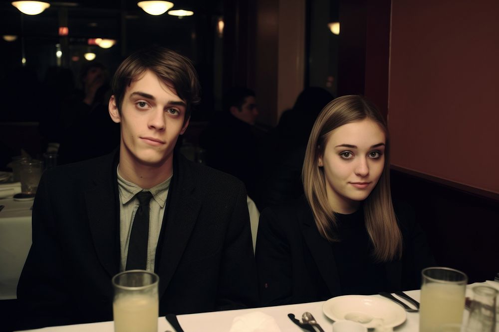 A teen couple dinner in a newyork restaurant portrait adult table.