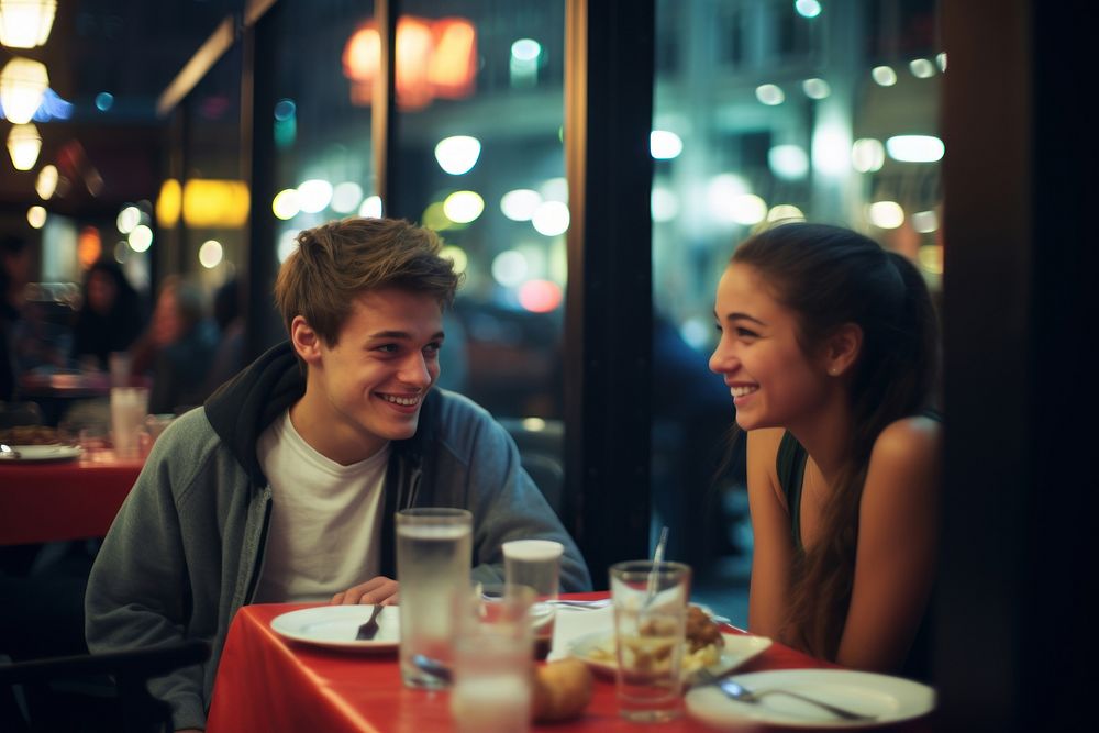 A teen couple dinner in a newyork restaurant architecture portrait table.