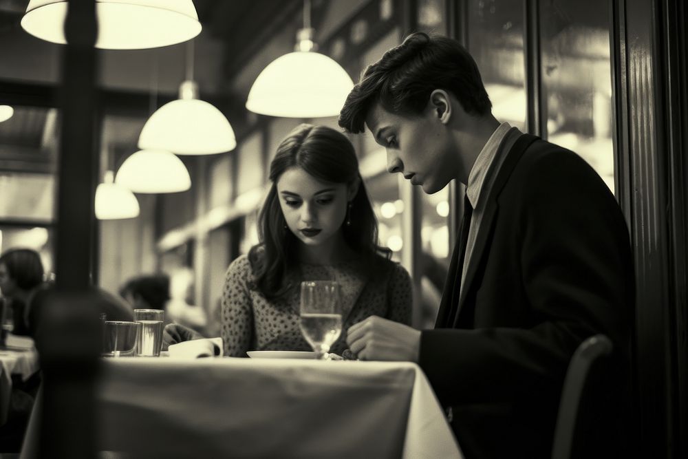 A teen couple dinner in a newyork restaurant adult table togetherness.