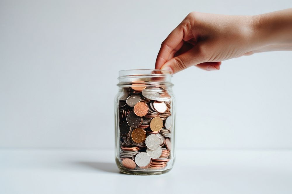 Hand holding coins in jar investment medication currency. AI generated Image by rawpixel.