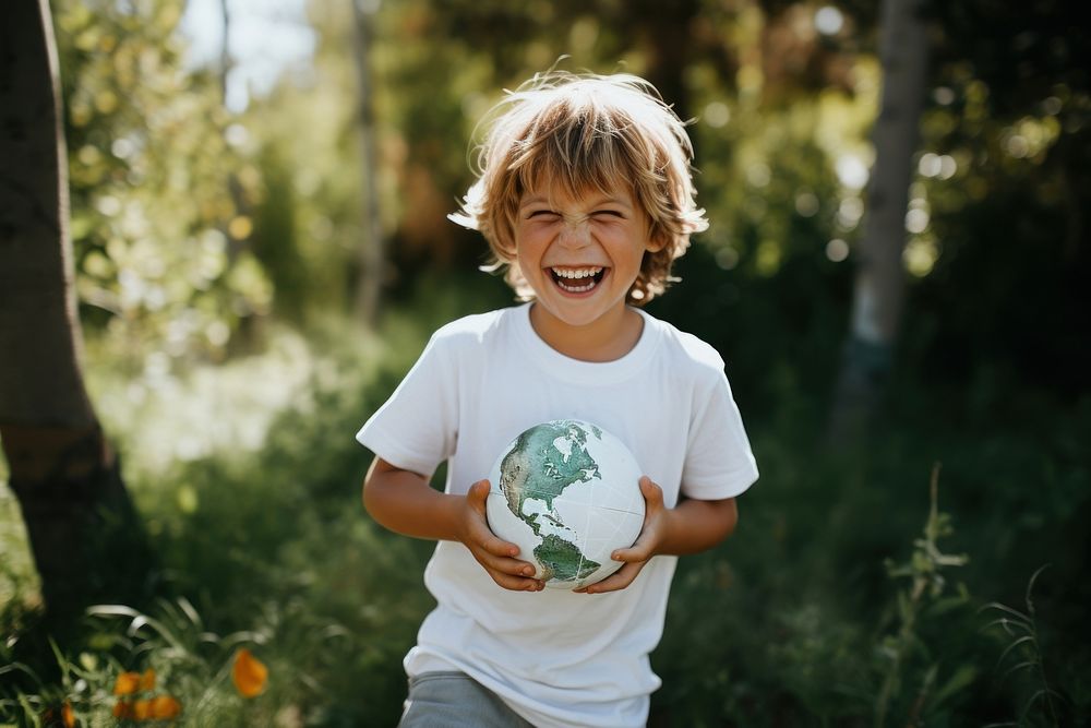 Holding the globe outdoors laughing nature.