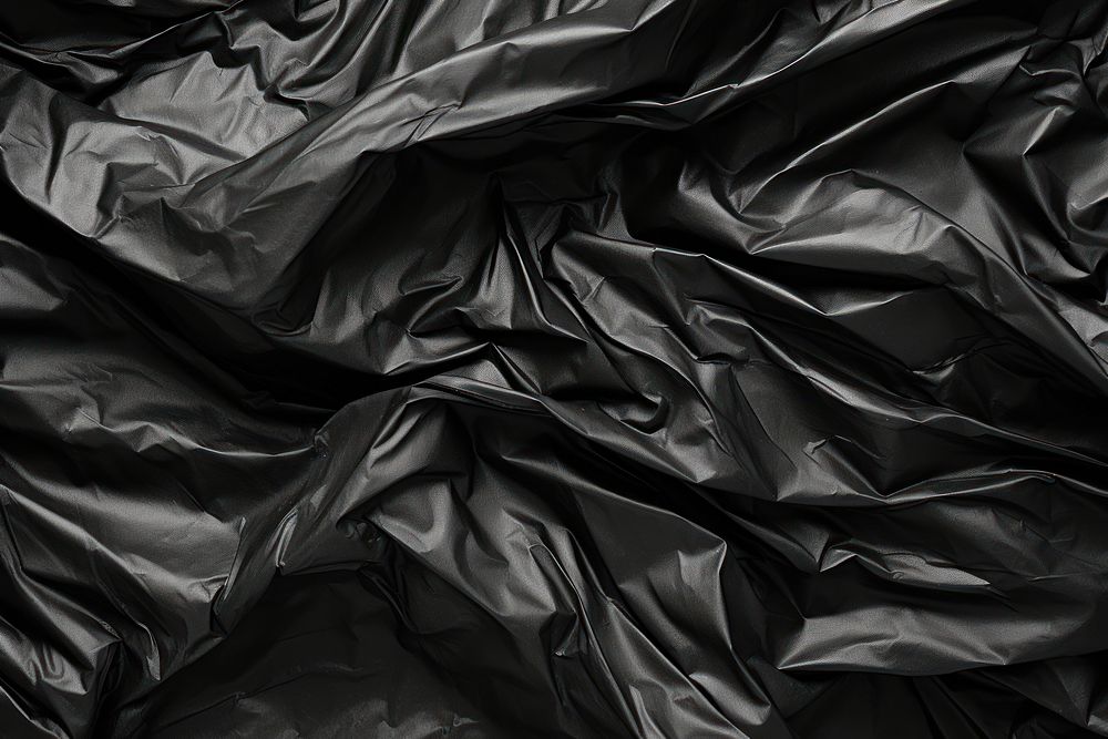  Wrinkled plastic wrap texture black backgrounds wrinkled. AI generated Image by rawpixel.