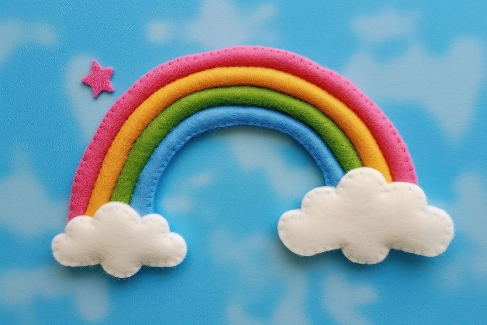 Photo of felt blue sky with rainbow textile nature toy.