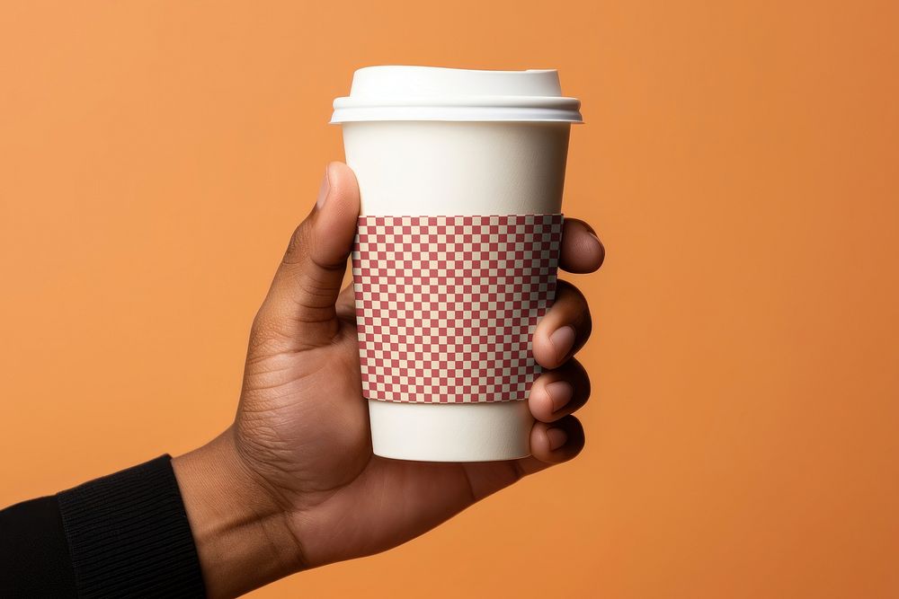 Hand holding takeaway coffee cup