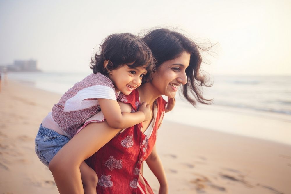 Indian mom piggyback baby on a beach photography outdoors portrait.
