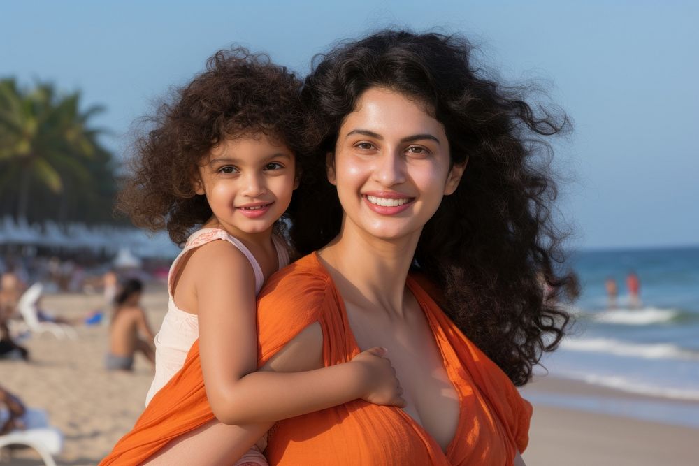 Indian mom piggyback baby on a beach photography portrait outdoors.