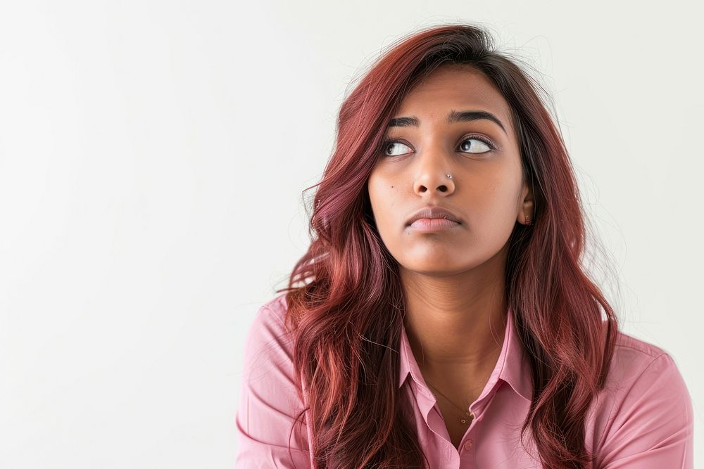 Young Indian business woman wearing a pink and skeptical expression portrait adult white background.