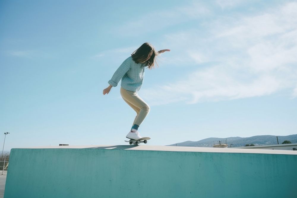 Skater girl jump and rides on skateboard at skate park footwear jumping sports.