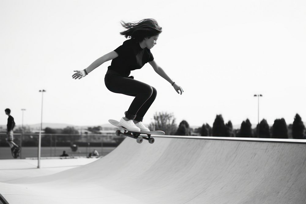 Skater girl jump and rides on skateboard at skate park footwear sports transportation.
