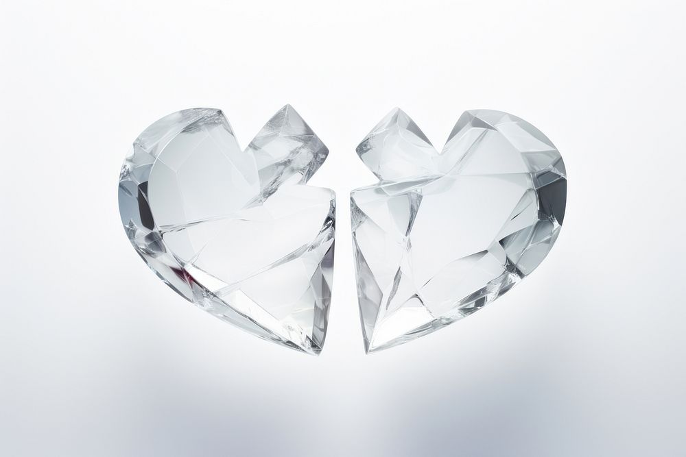 Transparent glass broken 2 half heart jewelry white white background.