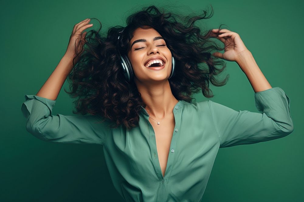 South asian woman headphones listening laughing. AI generated Image by rawpixel.