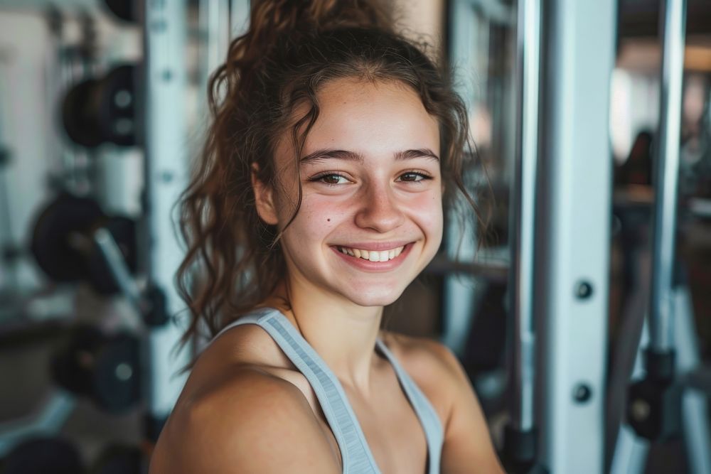 Young smiling woman at the gym smile adult bodybuilding.
