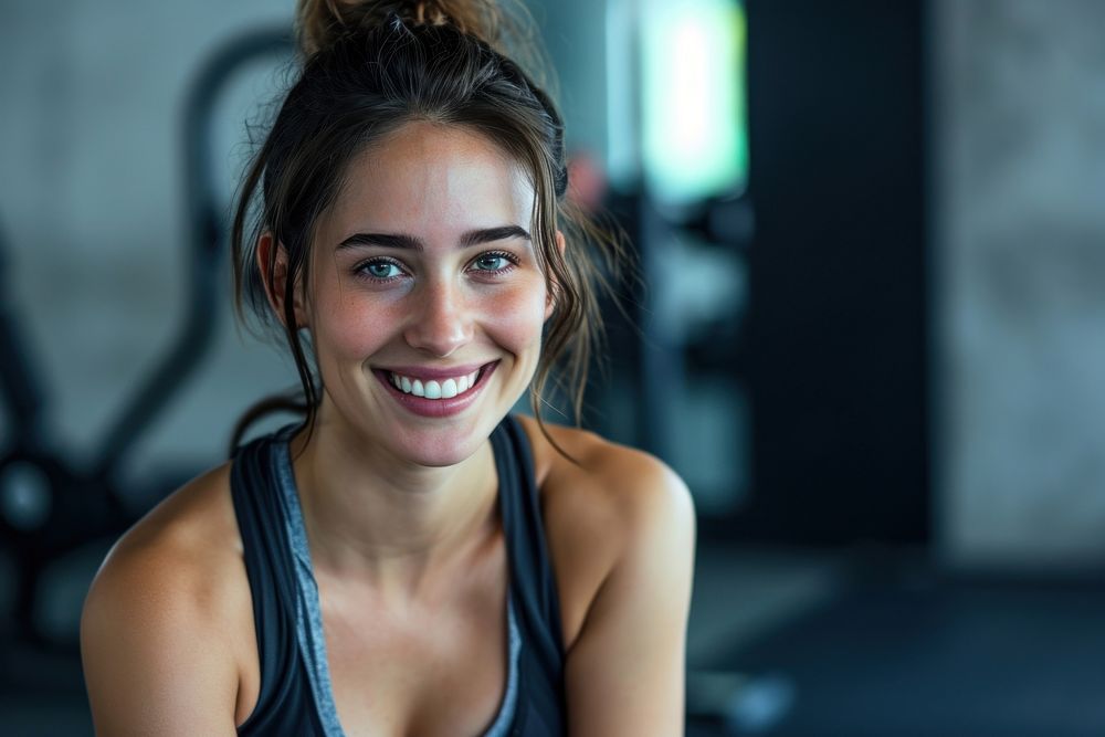 Young smiling woman having break after training at the gym smile adult determination.
