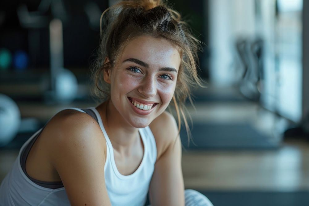 Young smiling woman having break after training at the gym smile adult exercising.