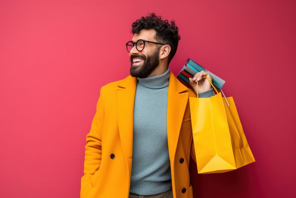 A joyful Hispanic gay holding shopping bags adult red consumerism.