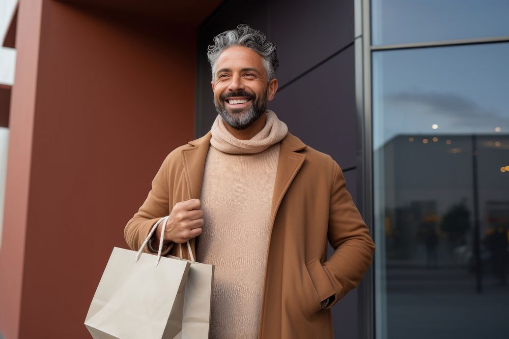 A joyful Hispanic gay holding shopping bags handbag adult smile.