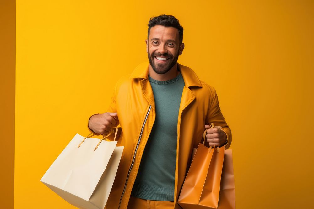 A joyful Hispanic gay holding shopping bags adult men consumerism.
