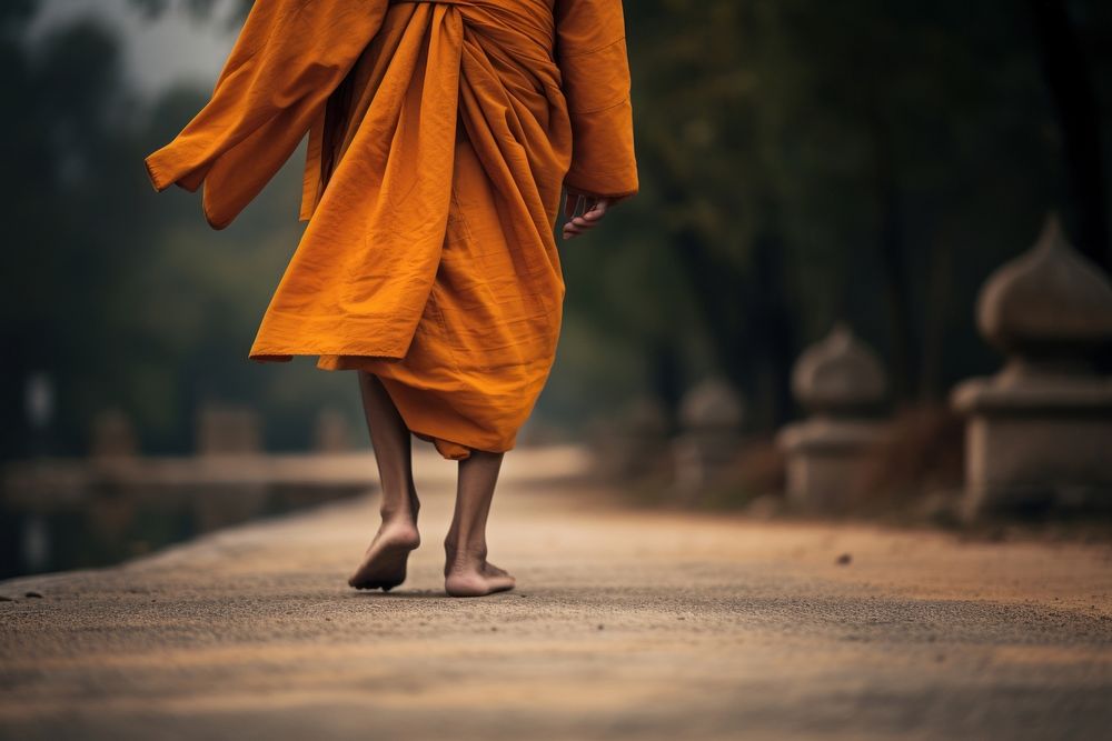 Thai monk walking on the road adult spirituality architecture.