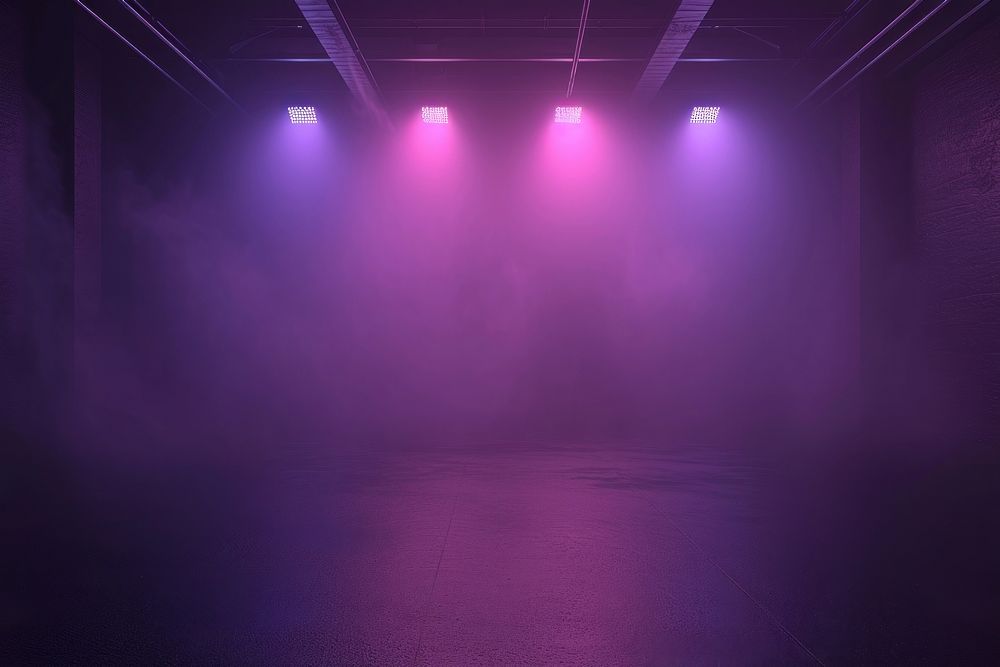 Black studio with fog violet and pink spotlights lighting purple stage.