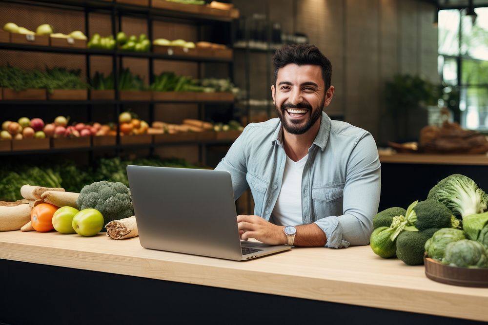 Hispanic man in shopping online theme food computer laptop.